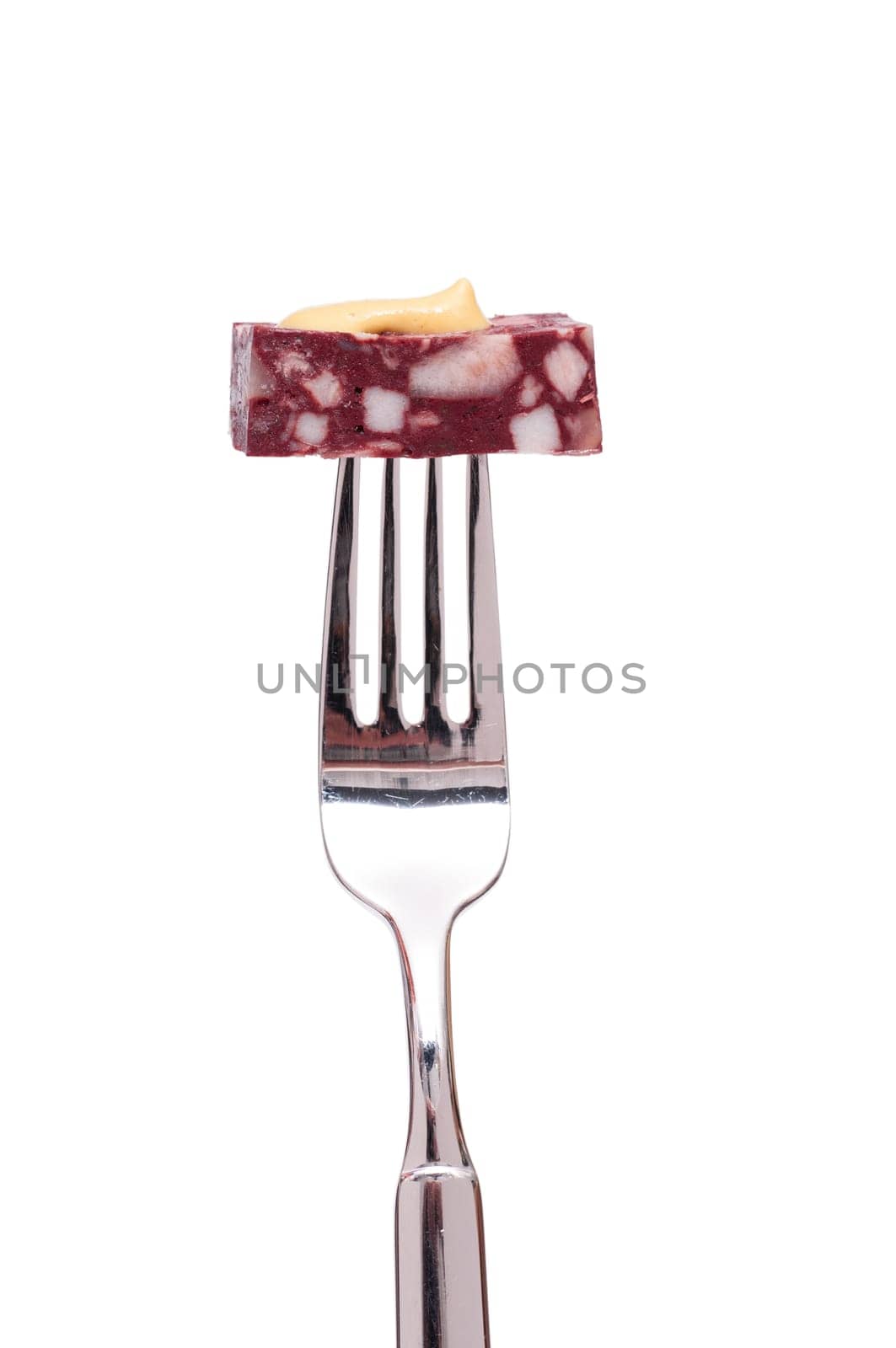 White cut-out greaves sausage with mustard on a fork