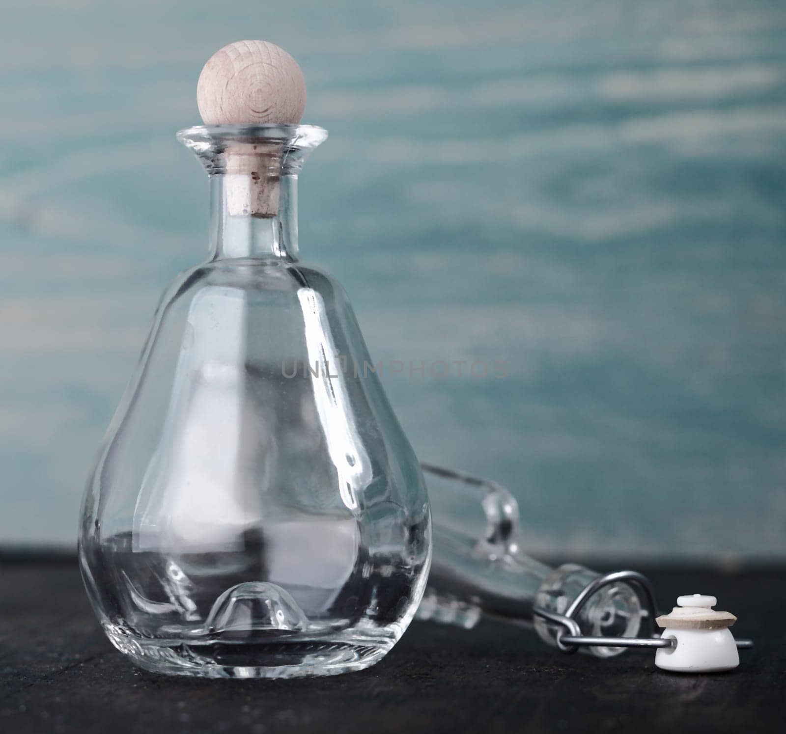Decorative empty conical glass decanter with a round wooden stopper