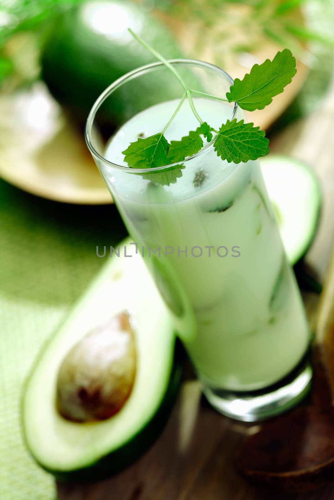 Tall glass of healthy velvety avocado smoothie rich in vitamins and monounsaturated fats