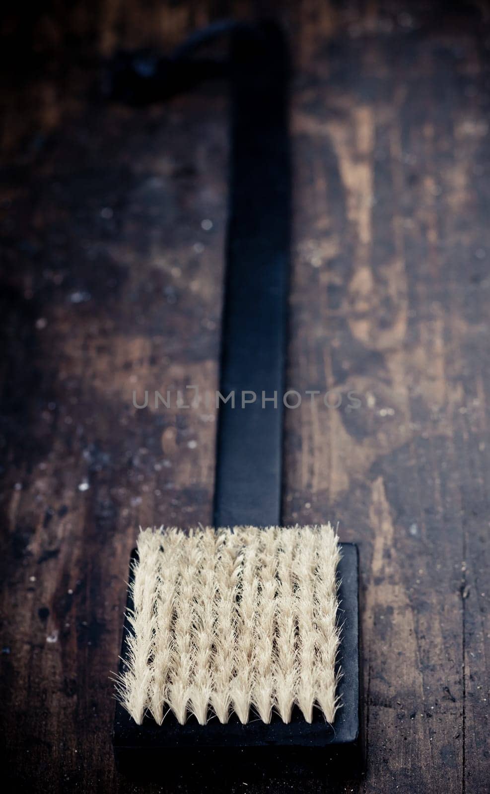Black bath brush on wooden rustic background