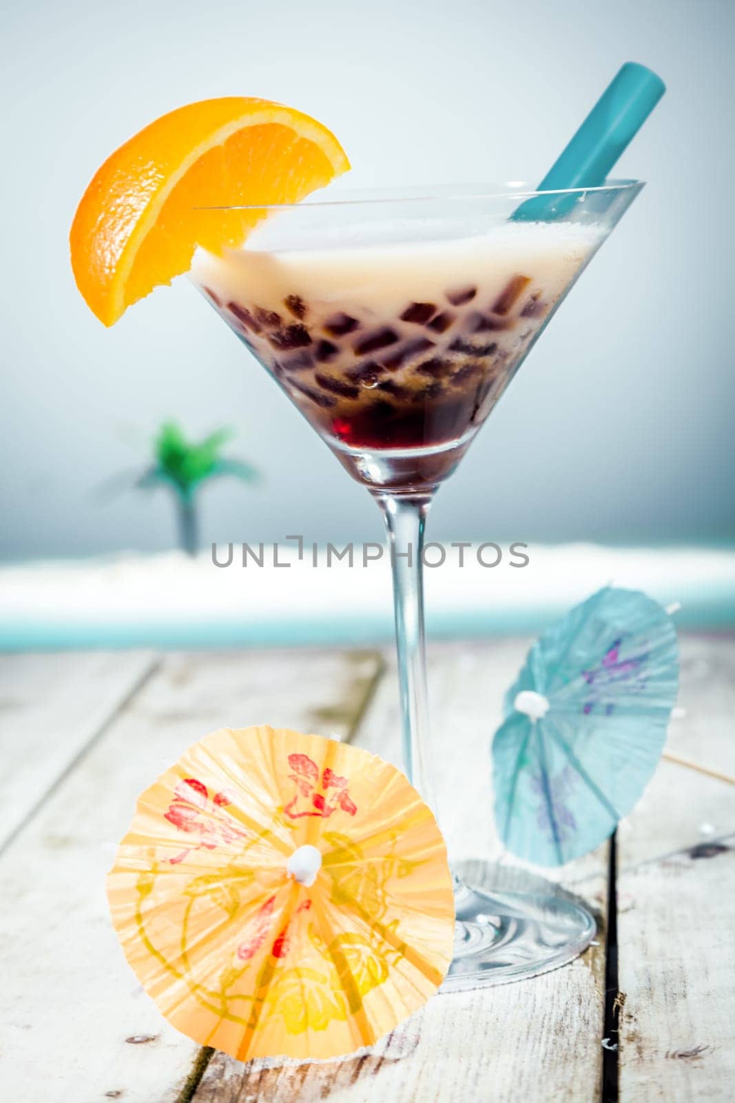Coffee Boba Tea with sweet ingredients and milk in front of the ocean