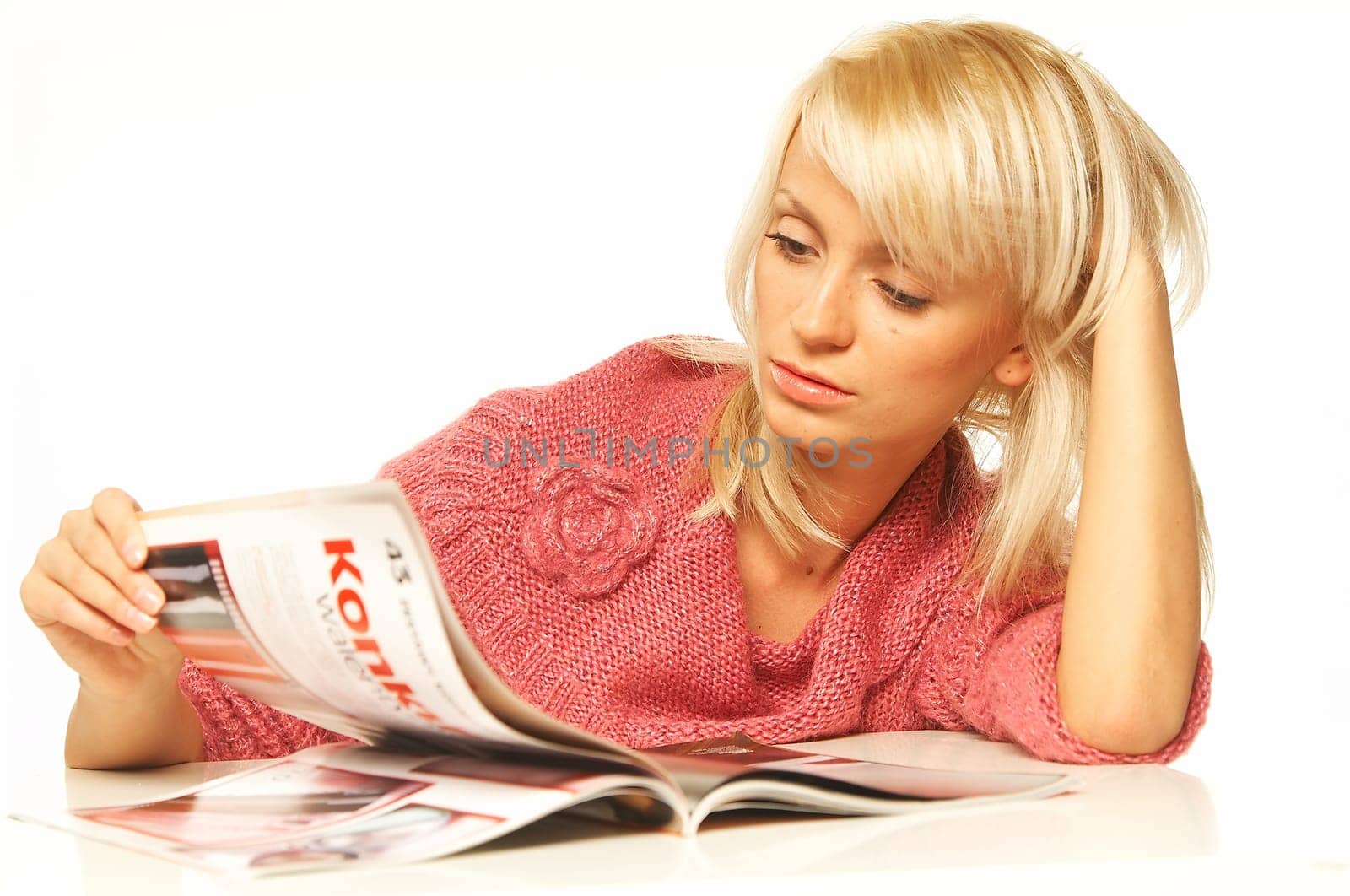 Young pretty women reading a color magazine.
