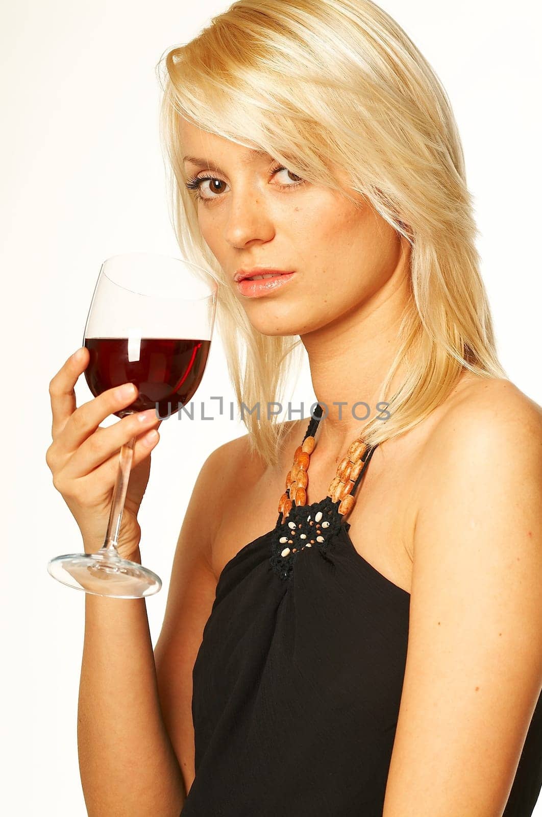 Pretty young blonde women with glass of red wine