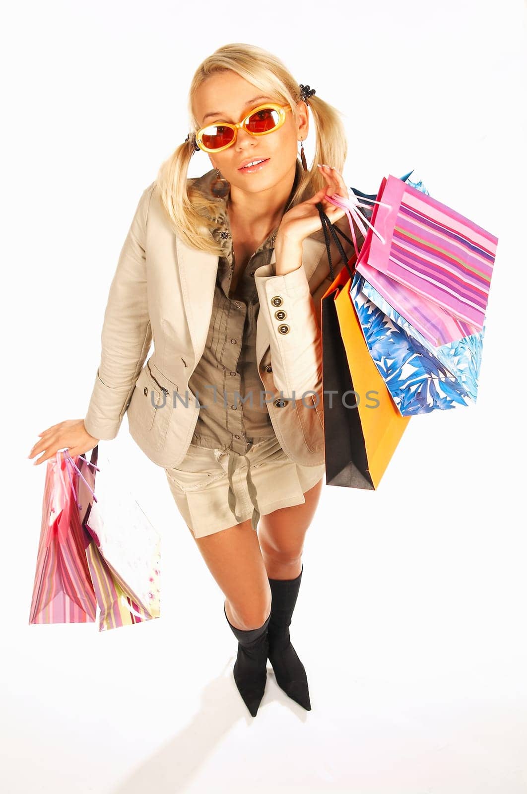 Blonde sexy girl with hands full of bags