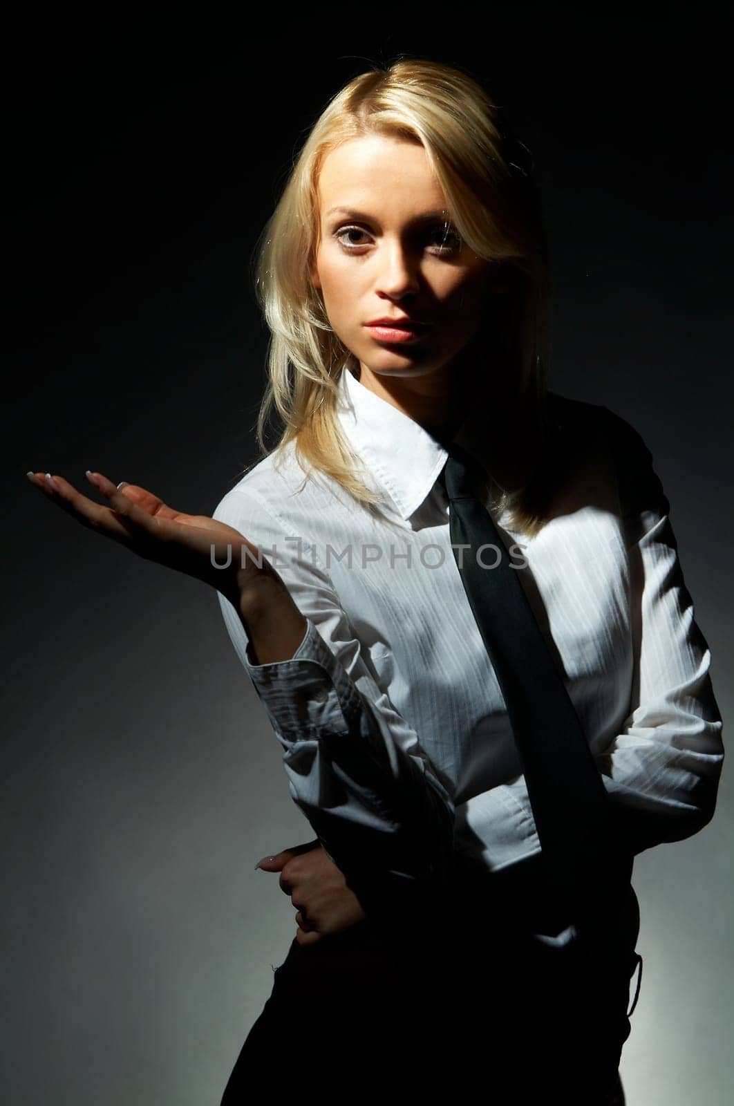 Blond model, business woman pose on black background