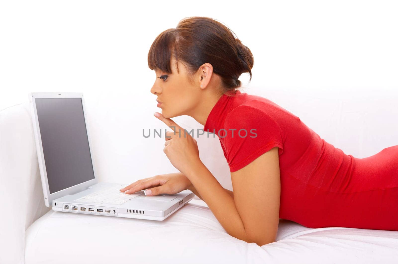 Young pretty women on white couch relaxing and using laptop computer