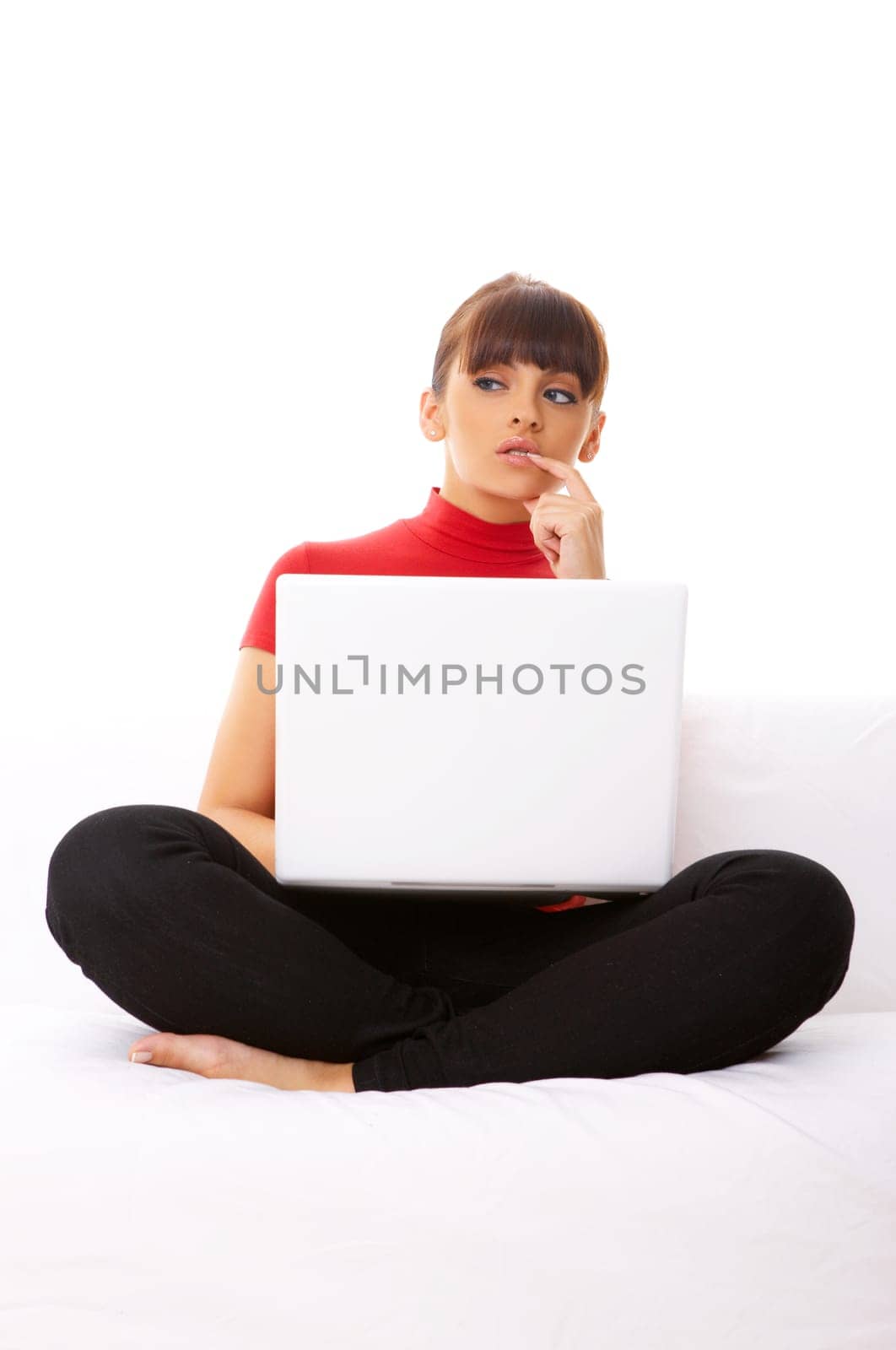 Young pretty women on white couch relaxing and using laptop computer