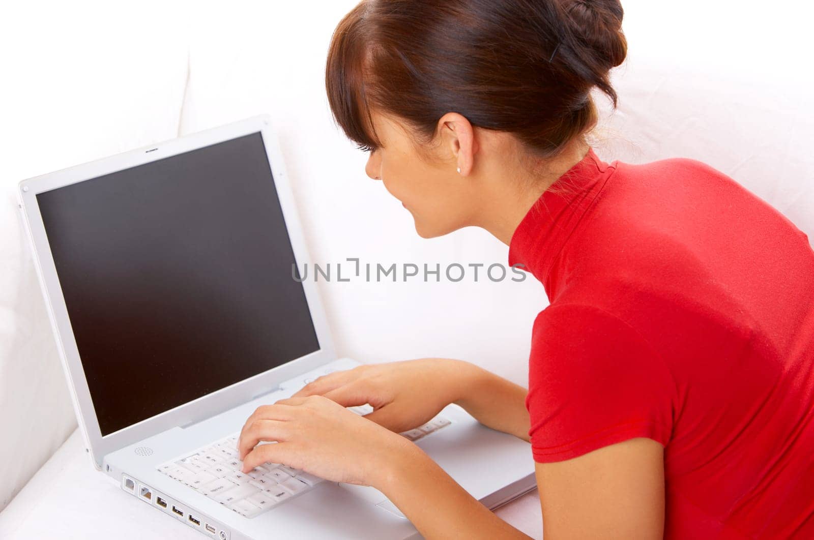 Young pretty women on white couch relaxing and using laptop computer