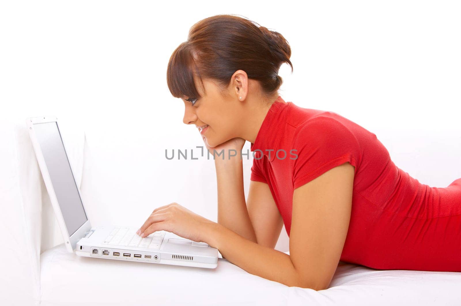 Young pretty women on white couch relaxing and using laptop computer