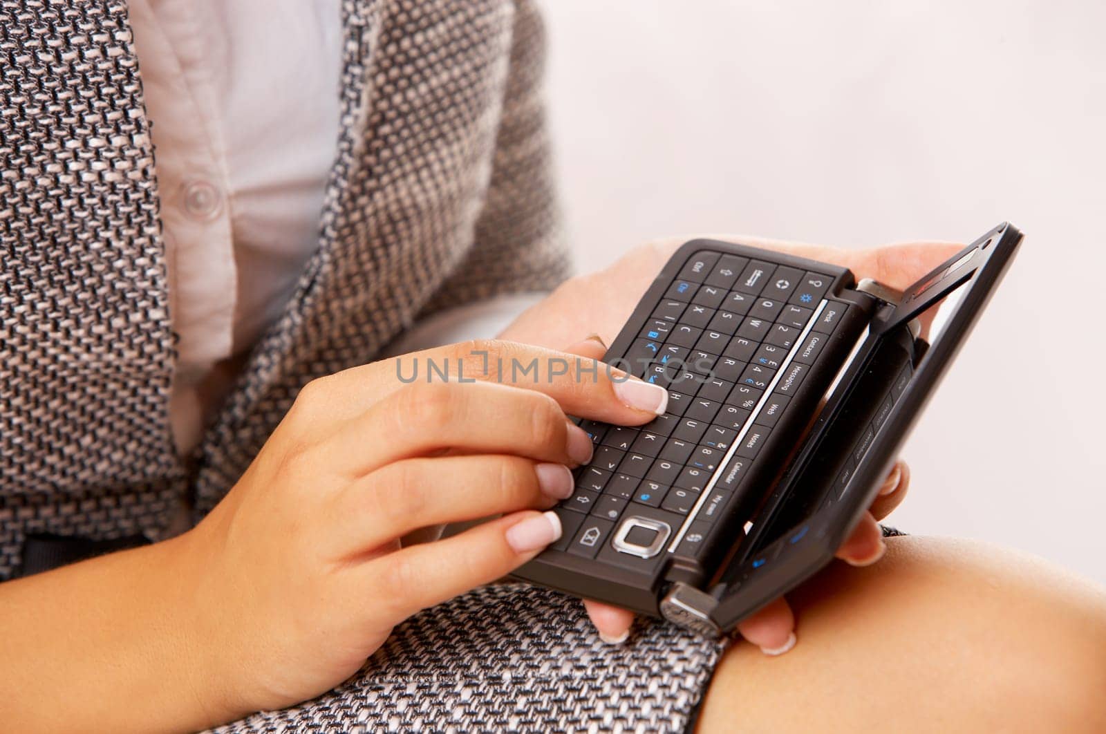 Beautiful business woman is using mobile telephone