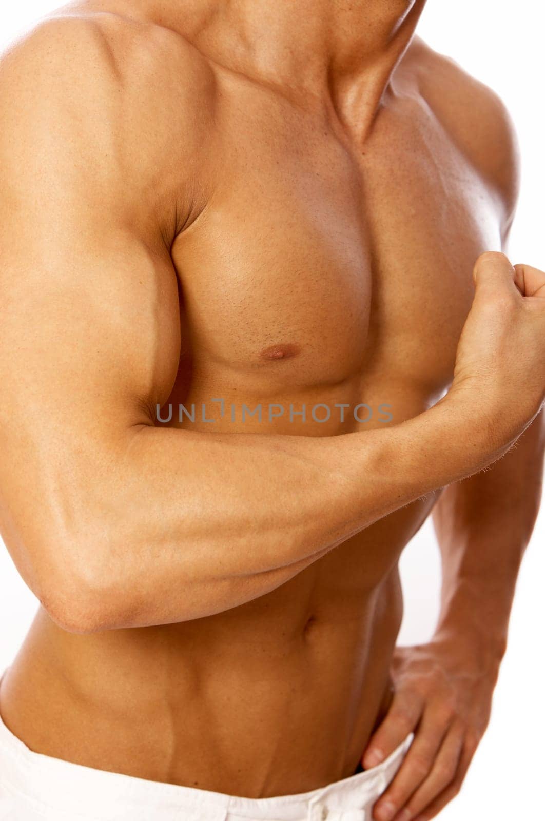 Muscular and tanned male torso isolated on white
