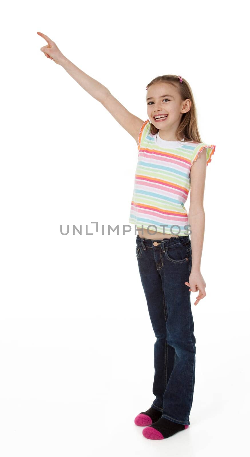 Cute little girl pointing upward on white background.