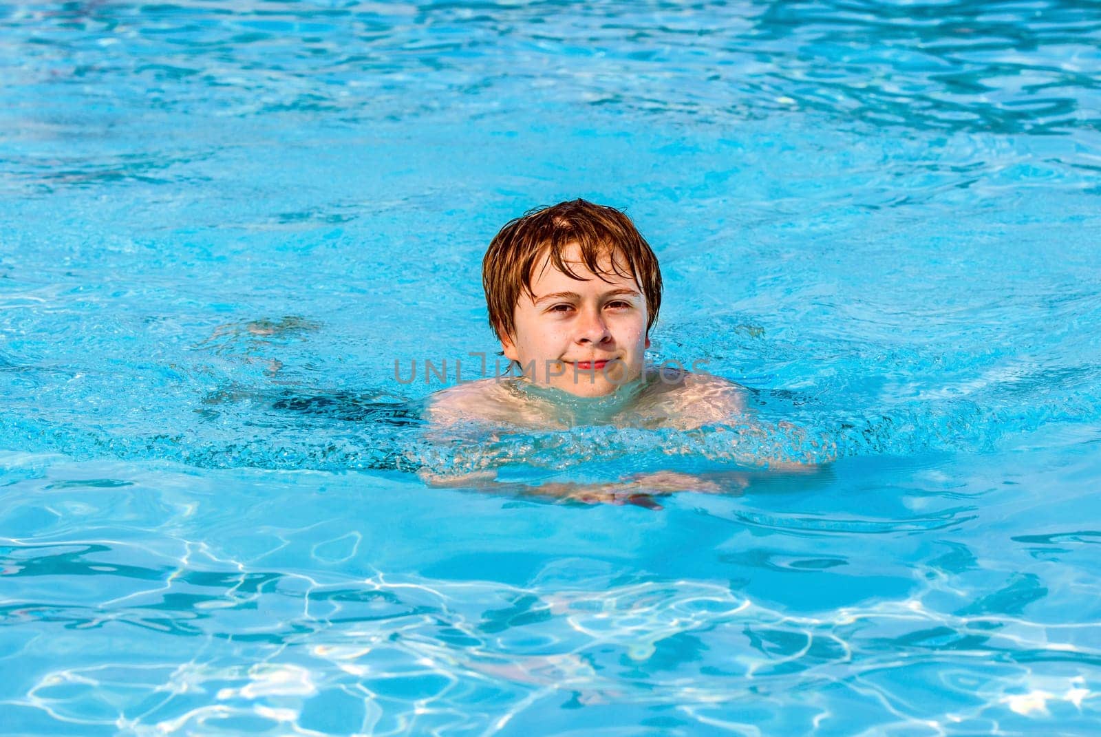 cute boy swimming in the pool
