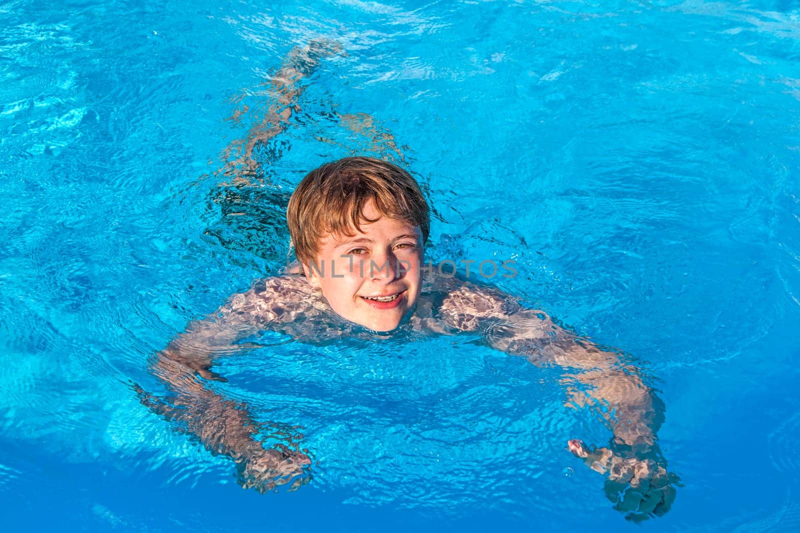 cute boy swimming in the pool