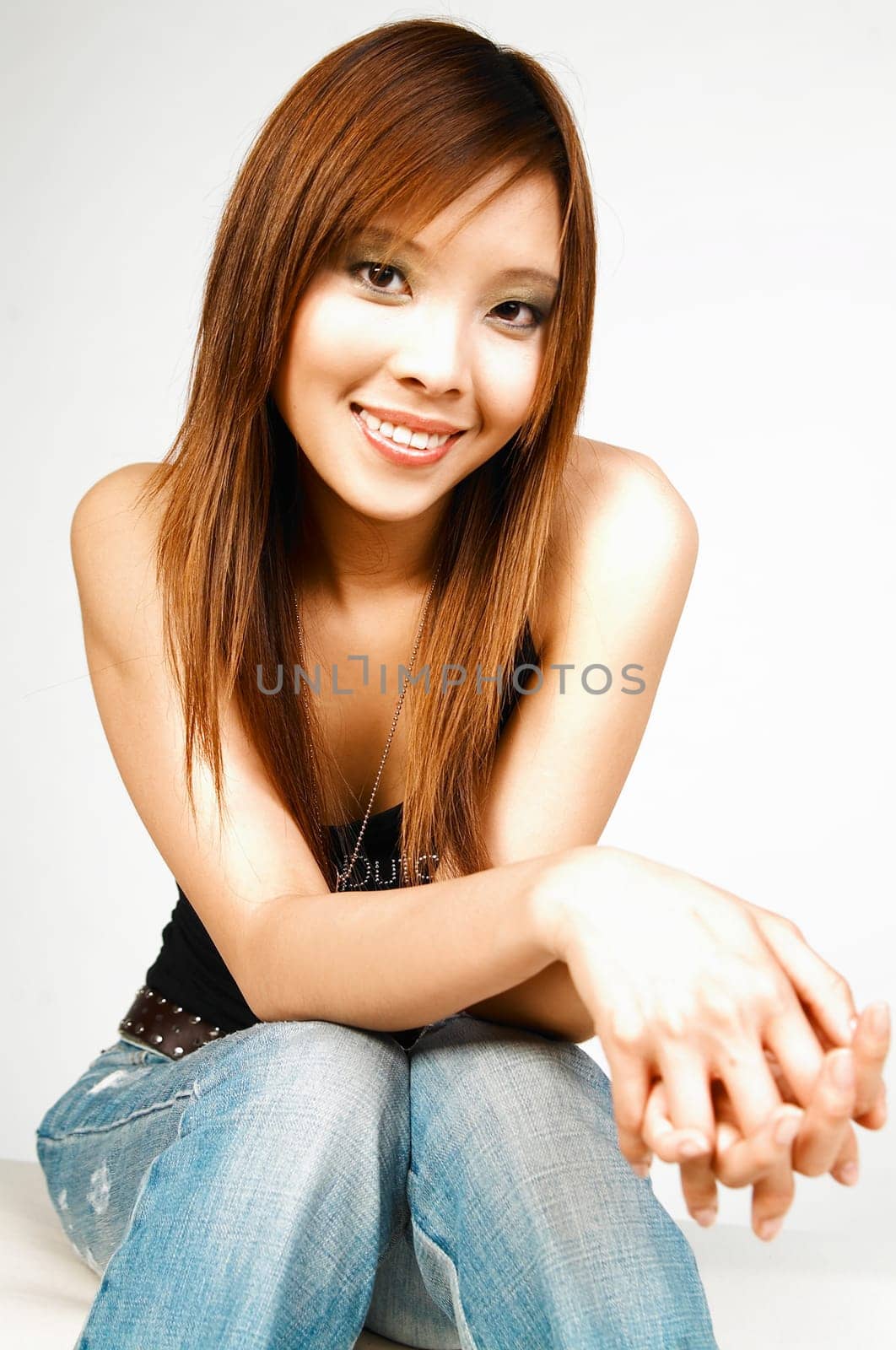 Asian beauty posing on white couch