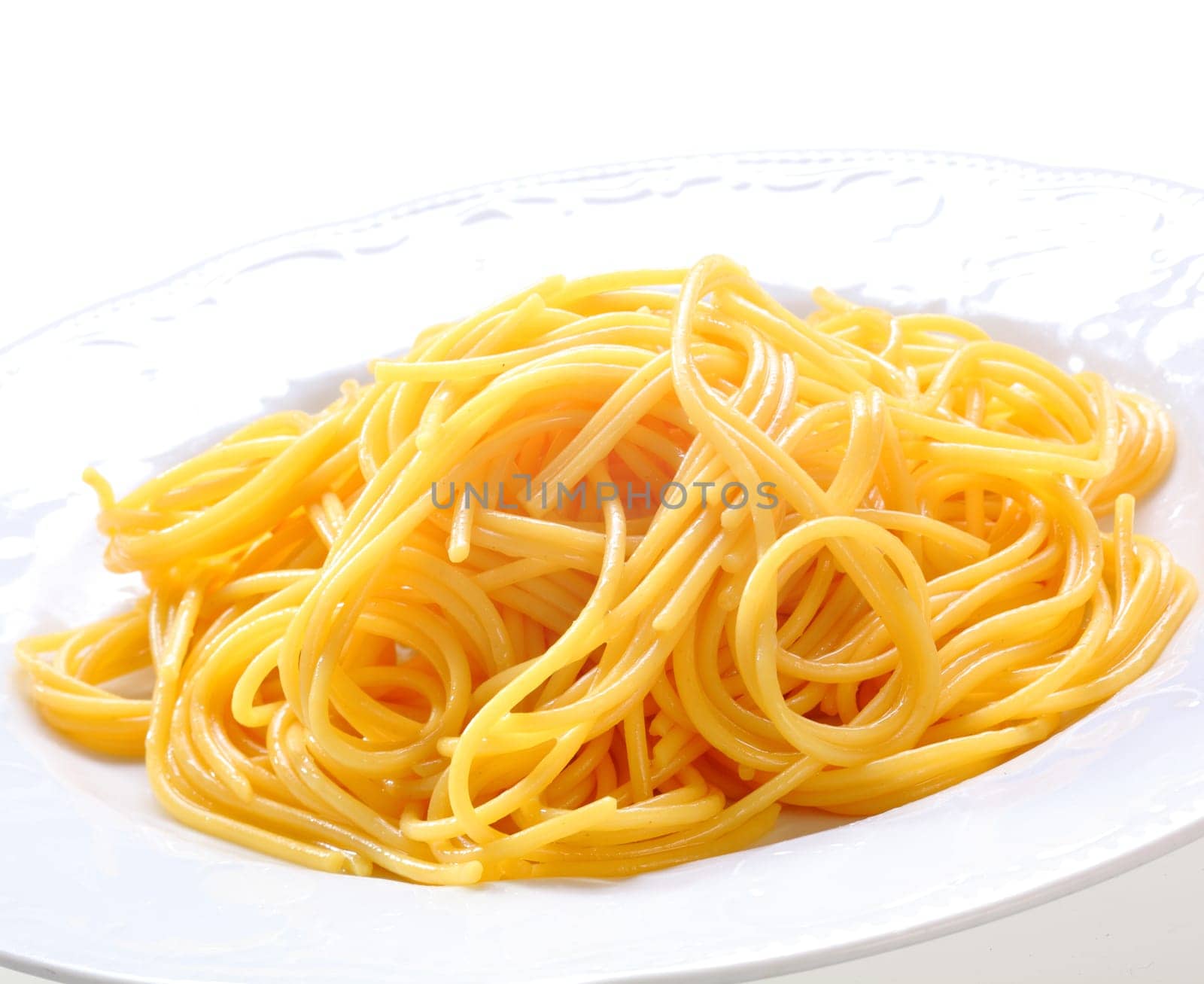 Plate Of Fresh Spaghetti. Freshly prepared spaghetti pasta without sauce on a white plate.