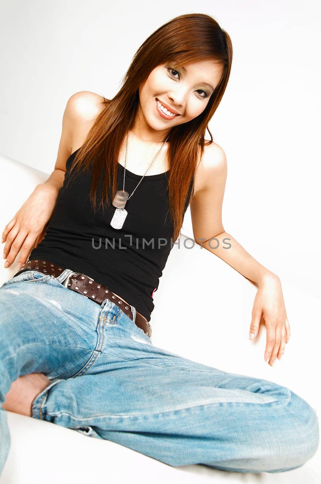 Asian beauty posing on white couch