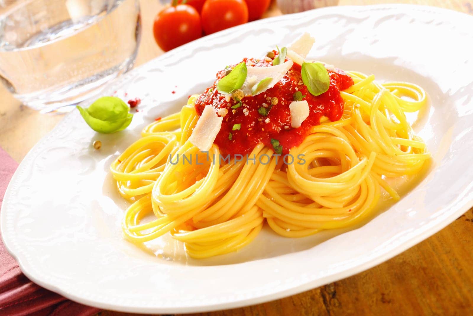 Plate of freshly prepared spaghetti bolognaise with a tomato sauce and cheese ready to be served.