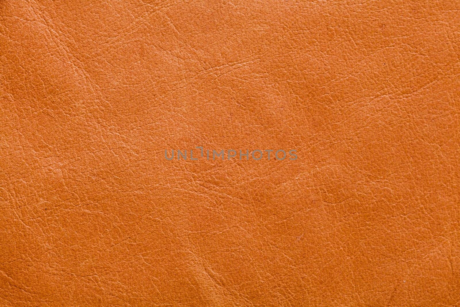 Abstract background of tan leather with creases and texture