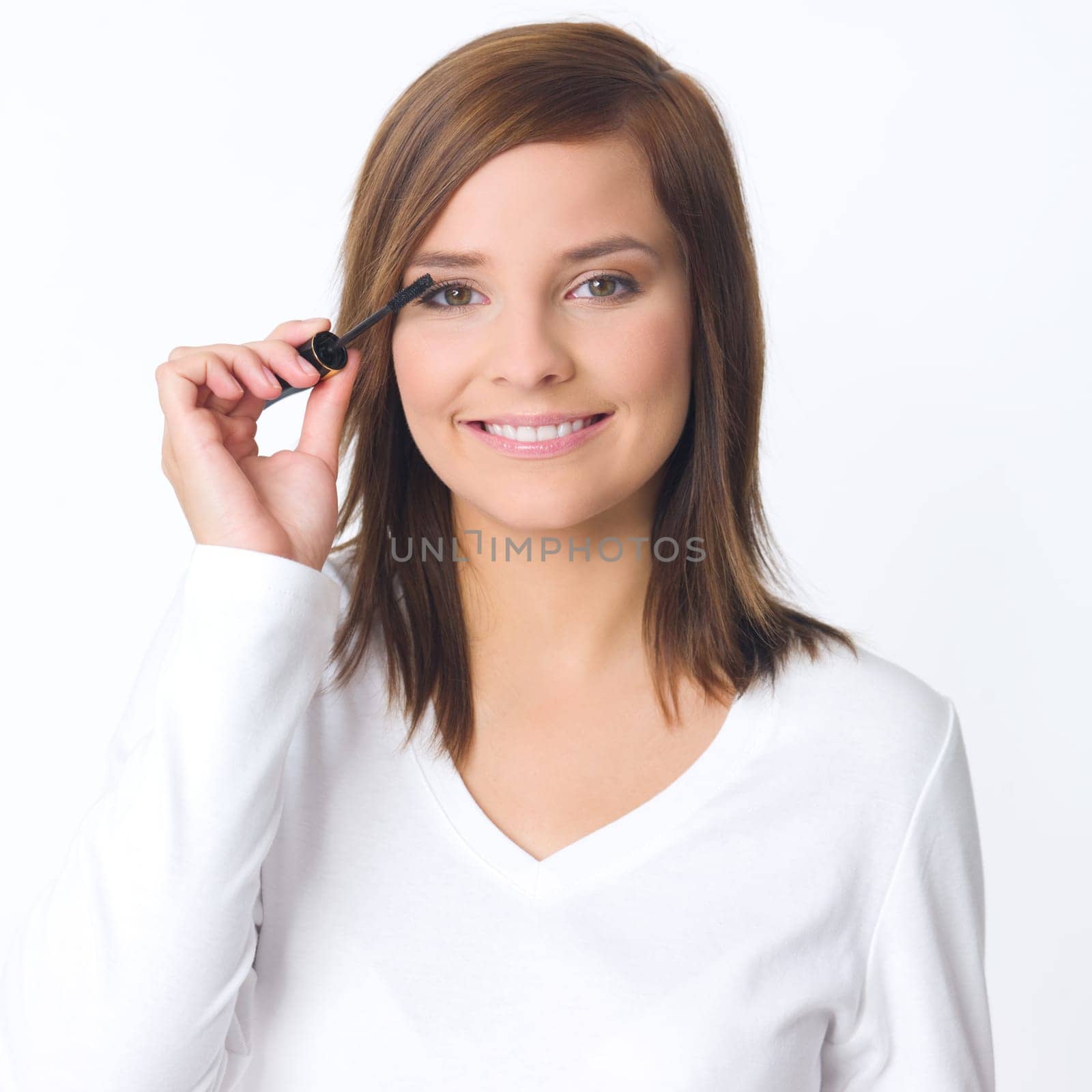 Portrait of beautiful young woman is doing her makeup