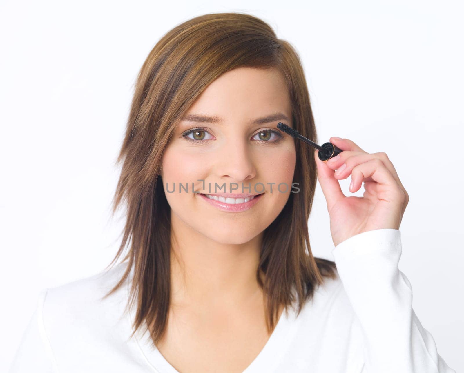 Portrait of beautiful young woman is doing her makeup