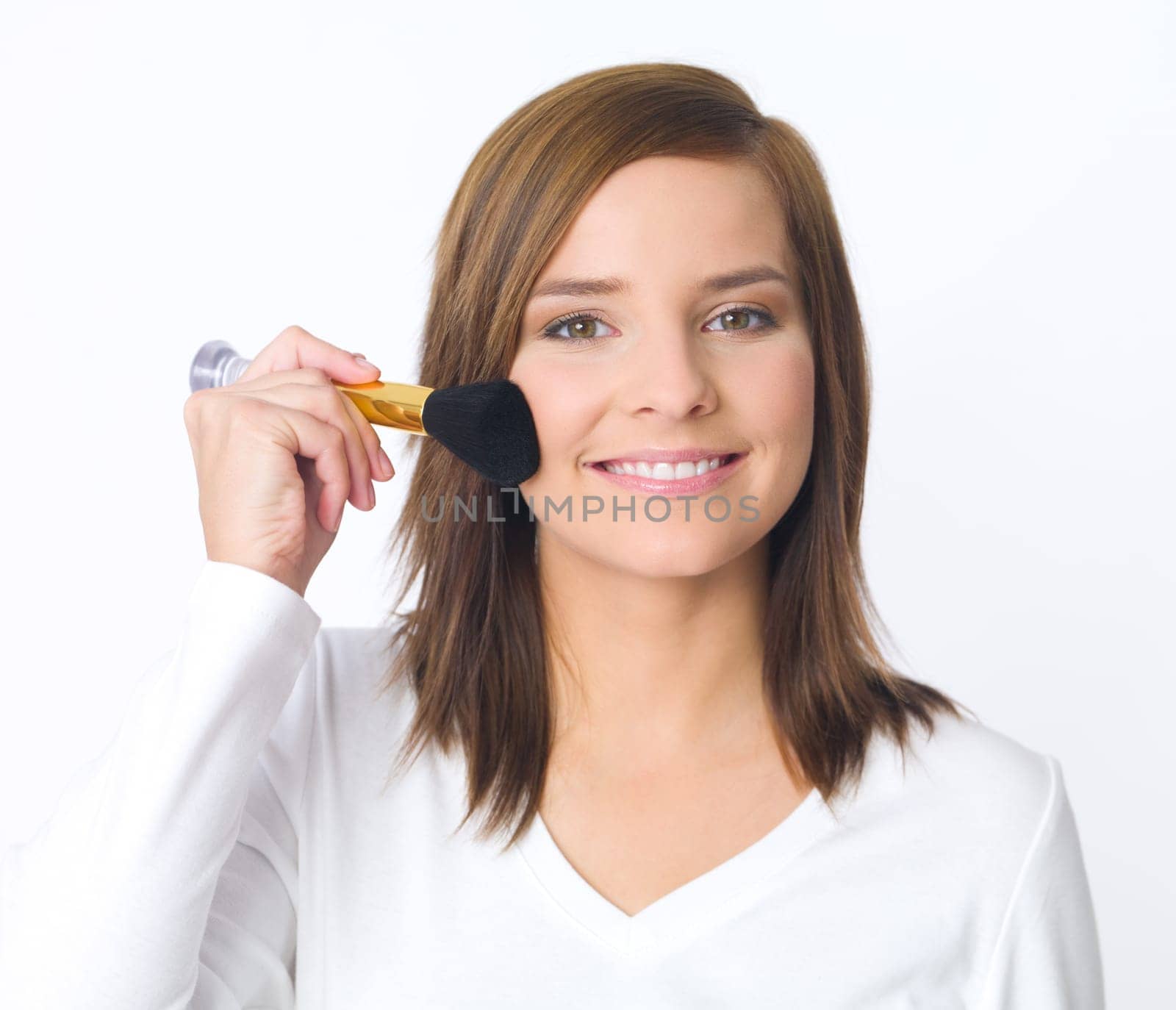 Portrait of beautiful young woman is doing her makeup