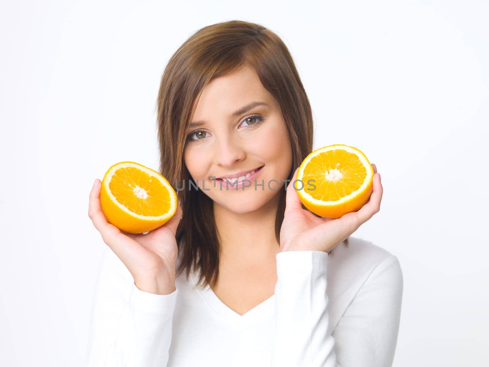 Portrait of beautiful young woman holding fresh orange fruit