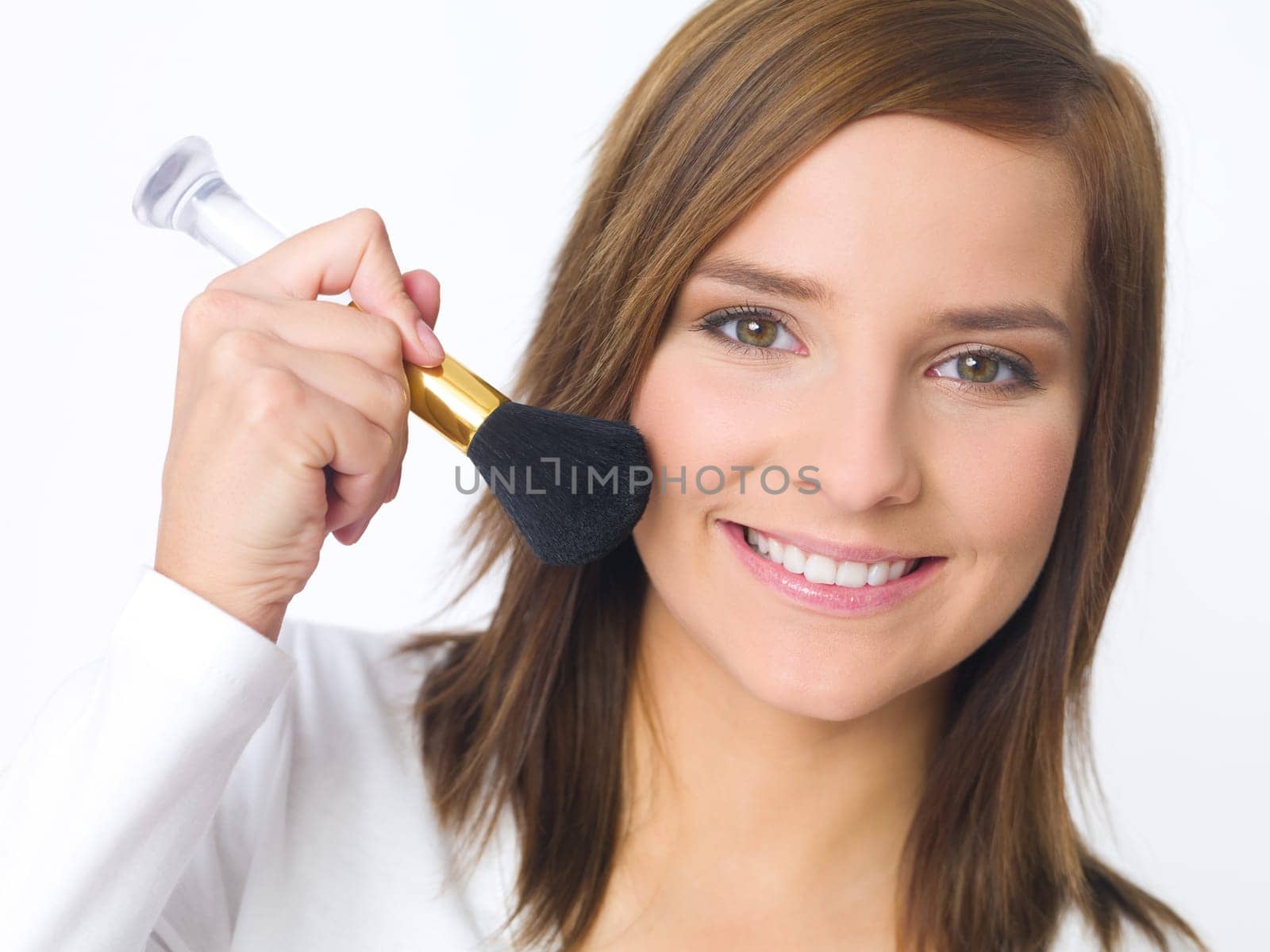 Portrait of beautiful young woman is doing her makeup