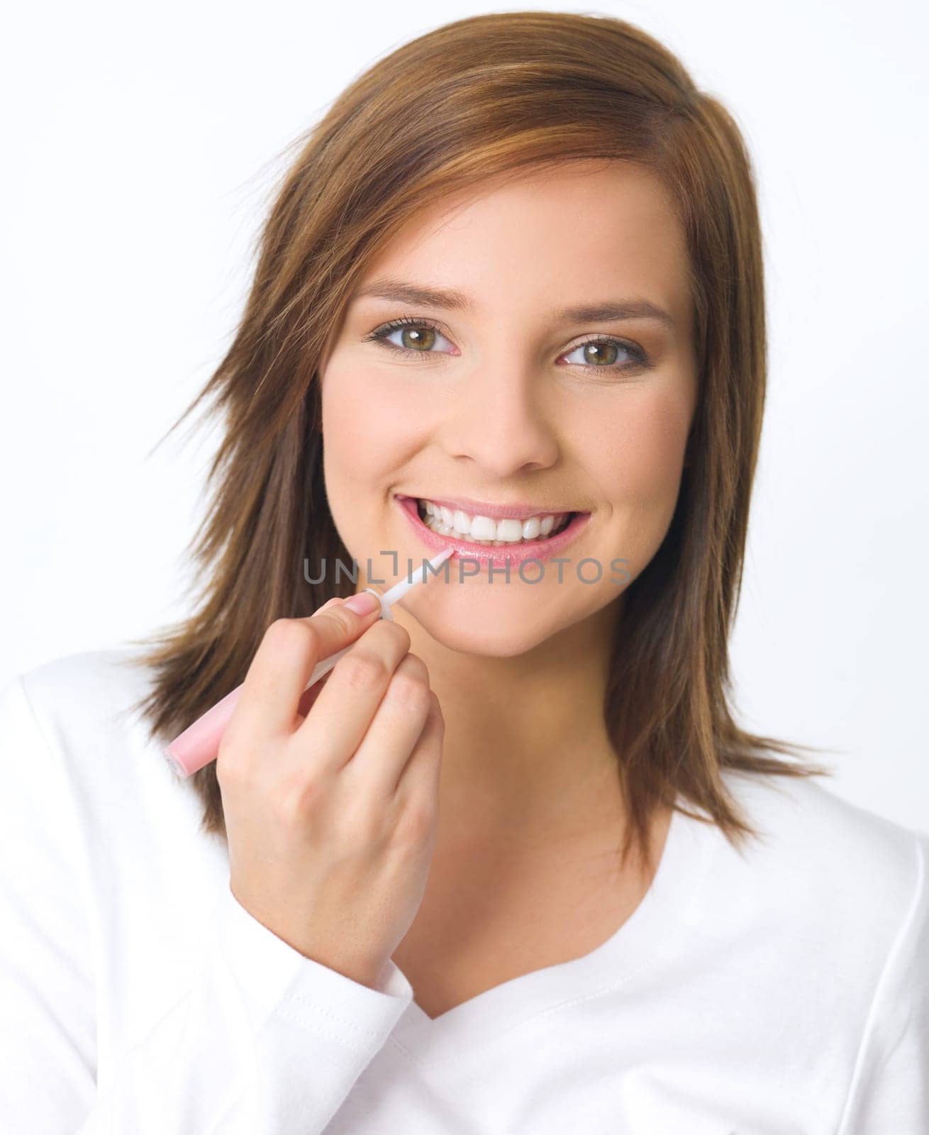 Portrait of beautiful young woman is doing her makeup