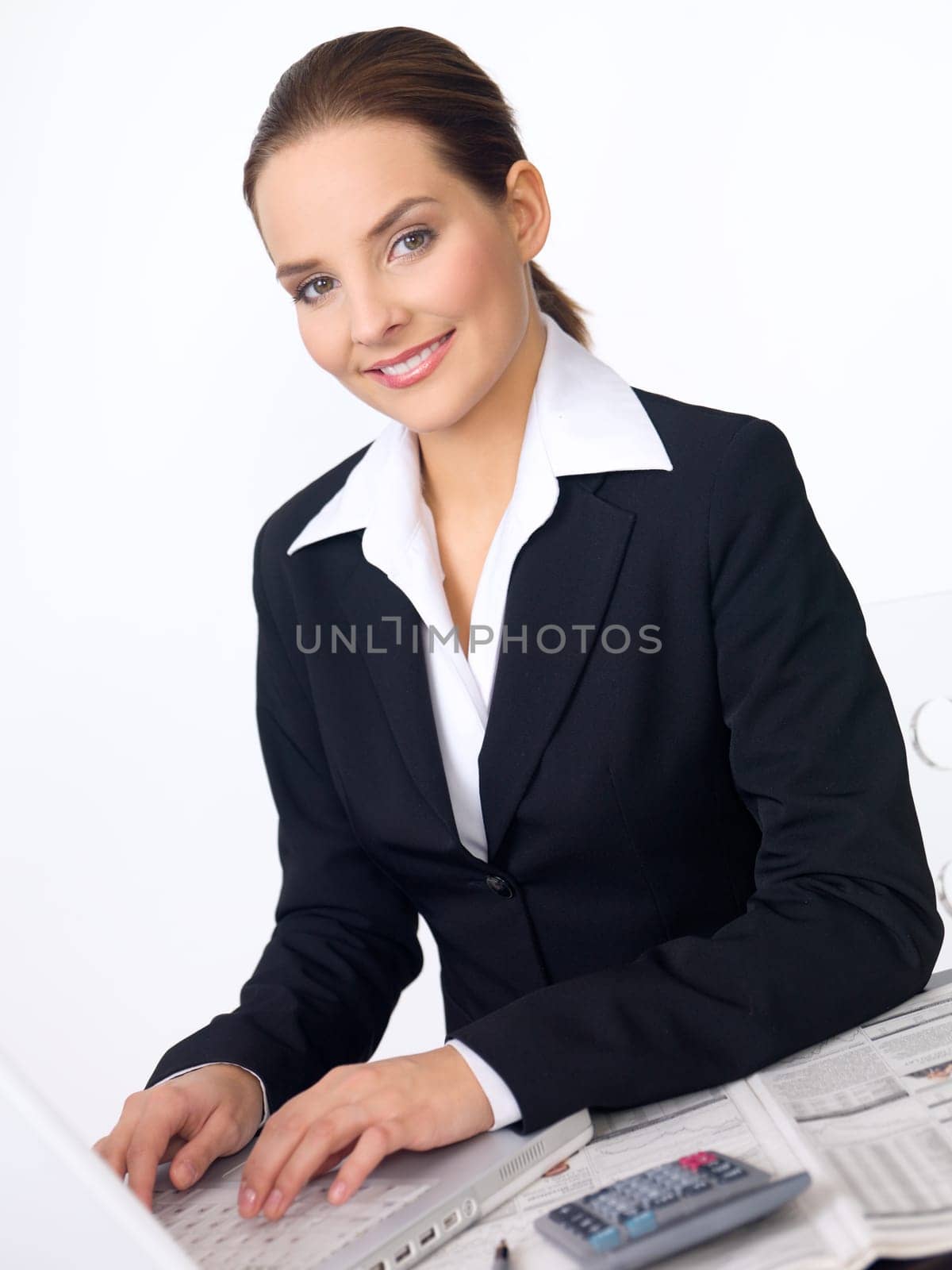 Portrait of beautiful and young business woman working on laptop