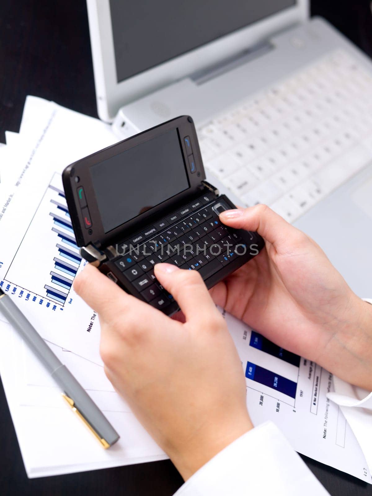 Portrait of beautiful and young business woman working on laptop