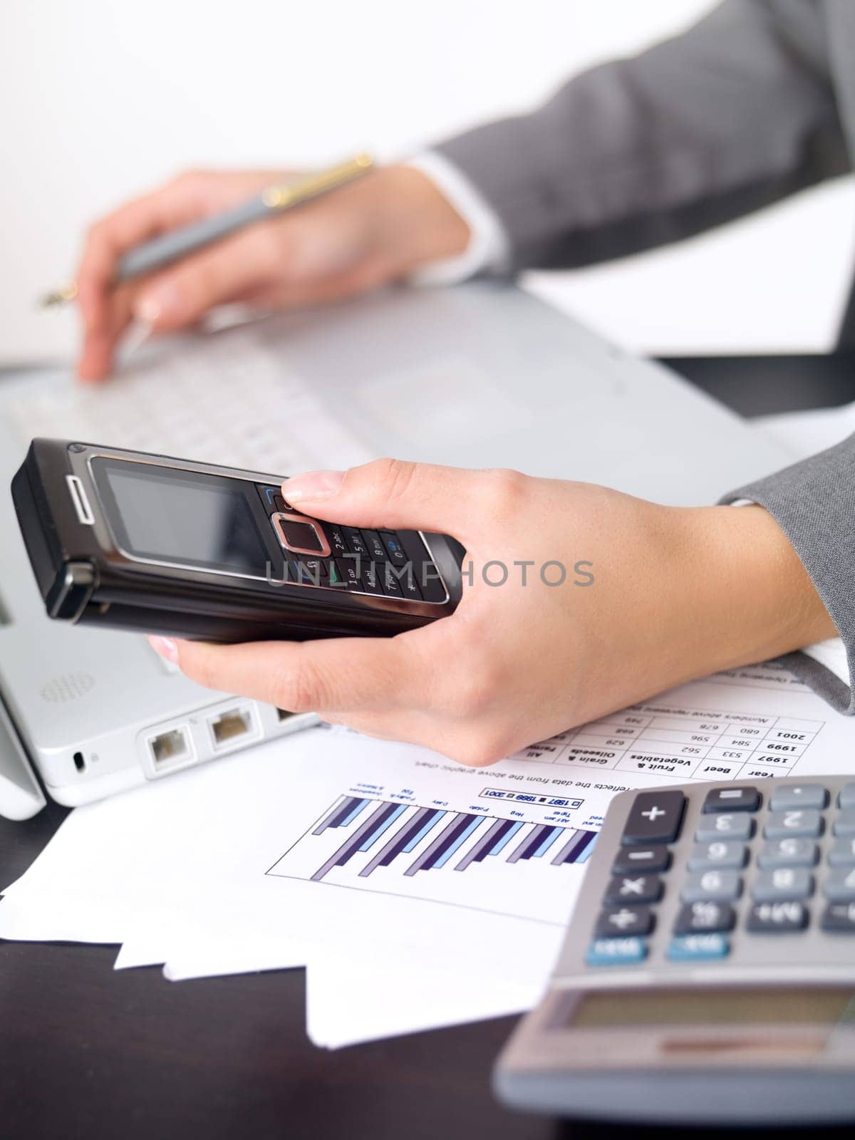 Portrait of beautiful and young business woman working on laptop