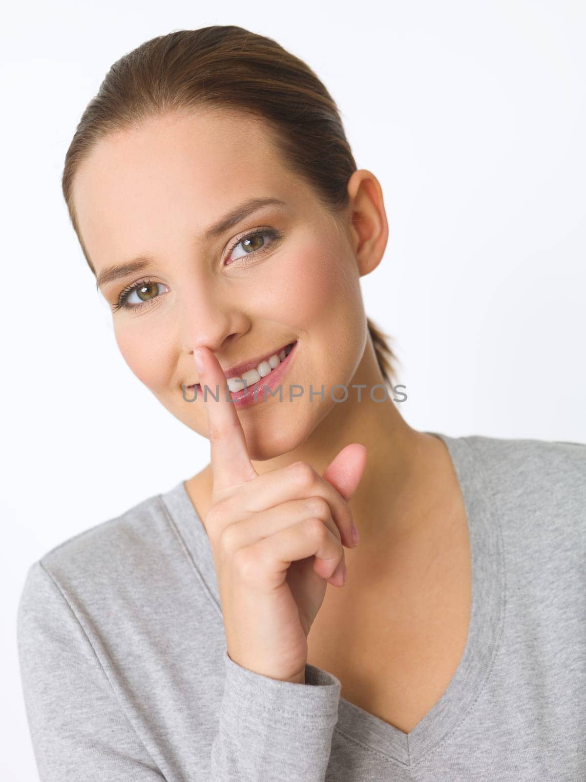 Portrait of beautiful young woman showing quiet gesture