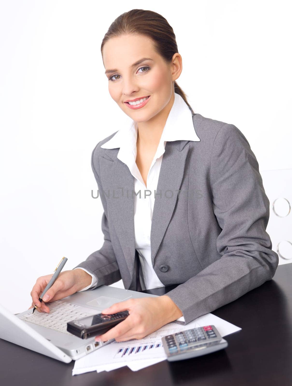 Portrait of beautiful and young business woman working on laptop