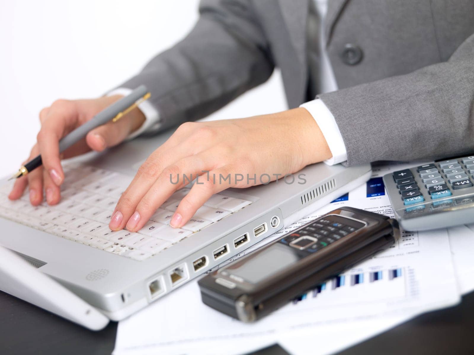 Portrait of beautiful and young business woman working on laptop