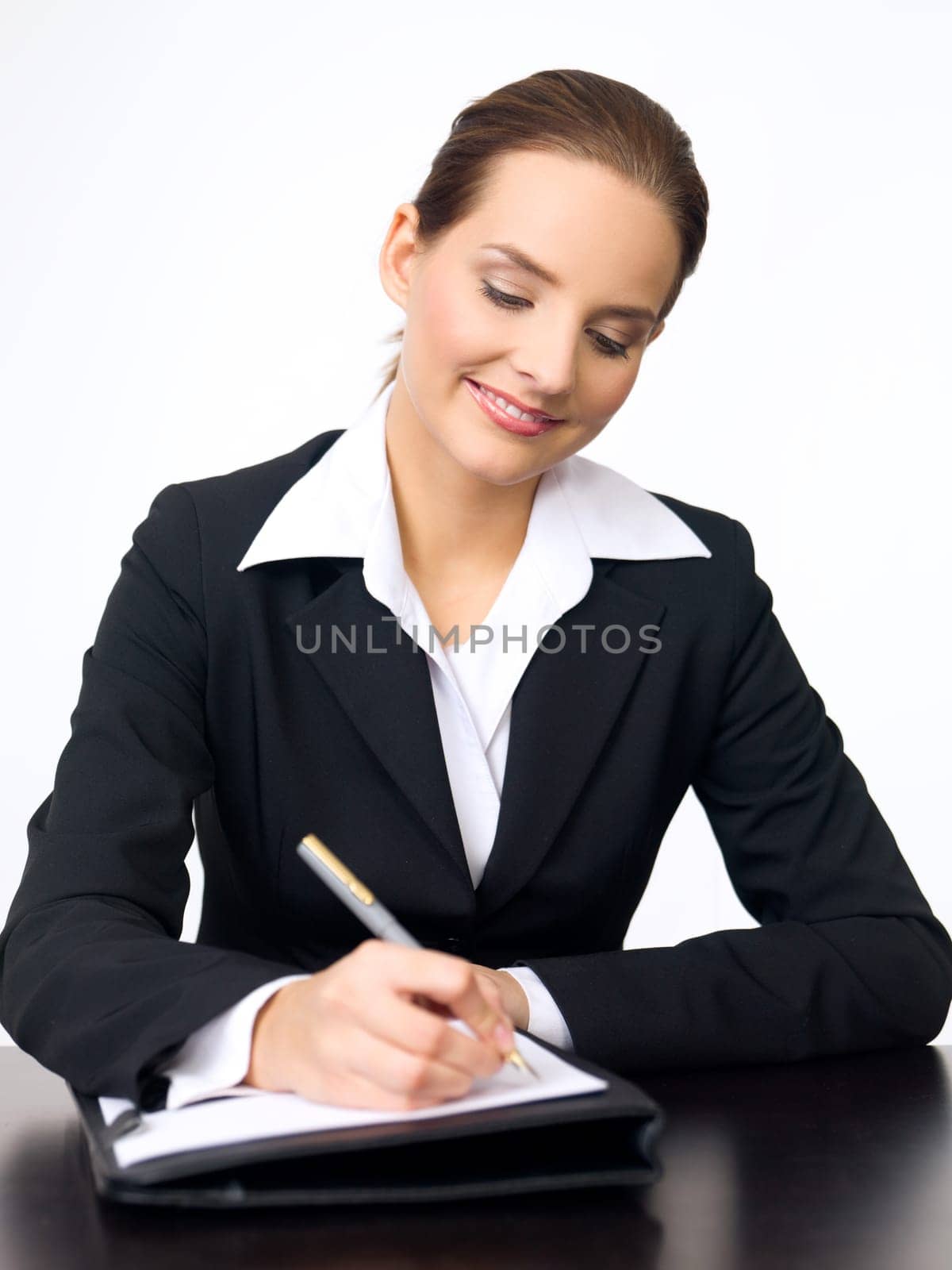 Portrait of beautiful and young business woman working at the desk