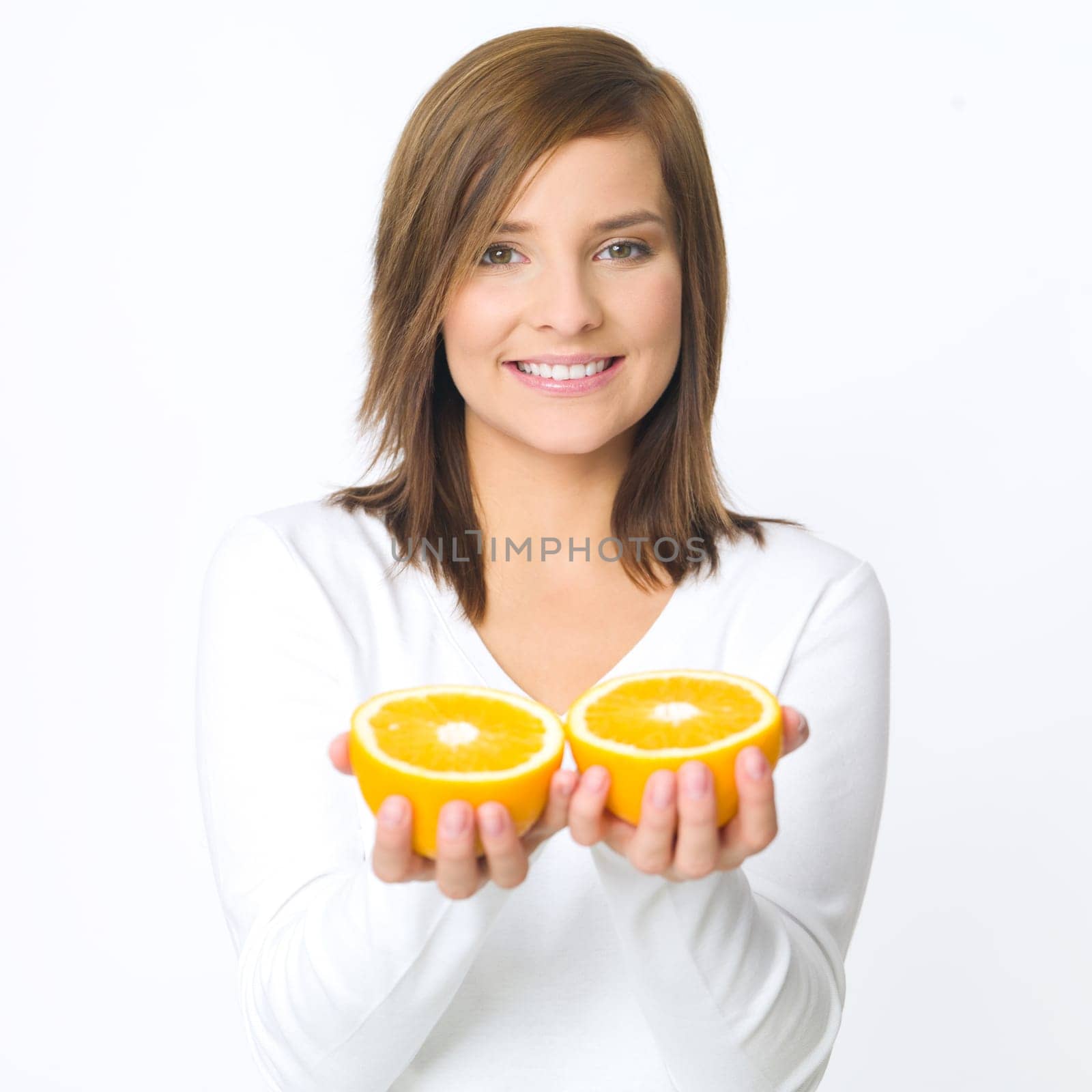 Portrait of beautiful young woman holding fresh orange fruit