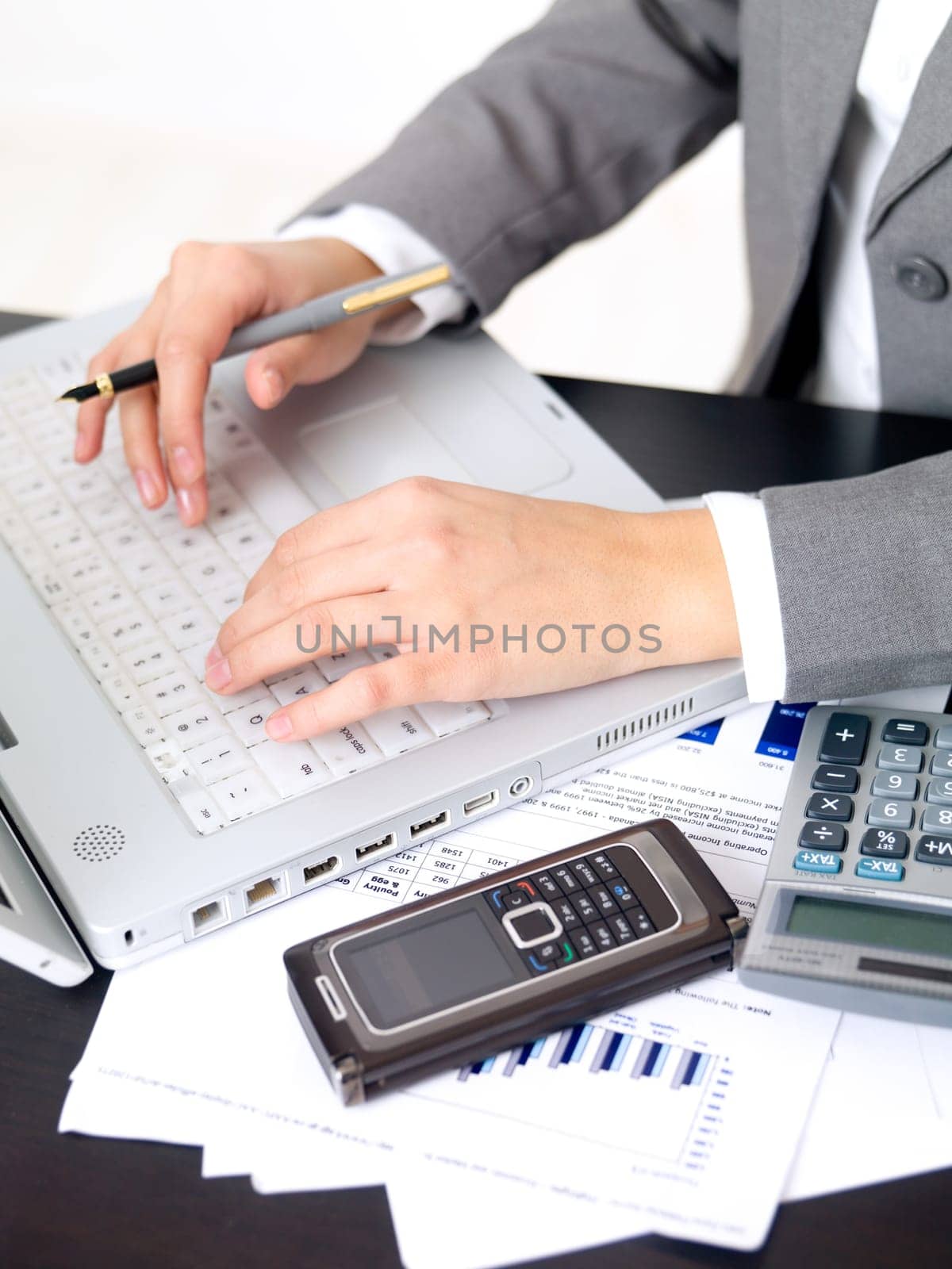 Portrait of beautiful and young business woman working on laptop