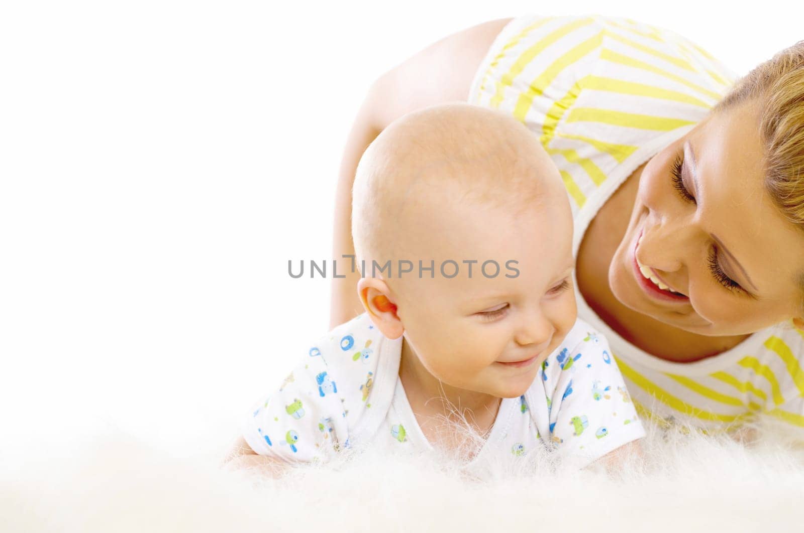 Young attractive mother kissing cute little baby