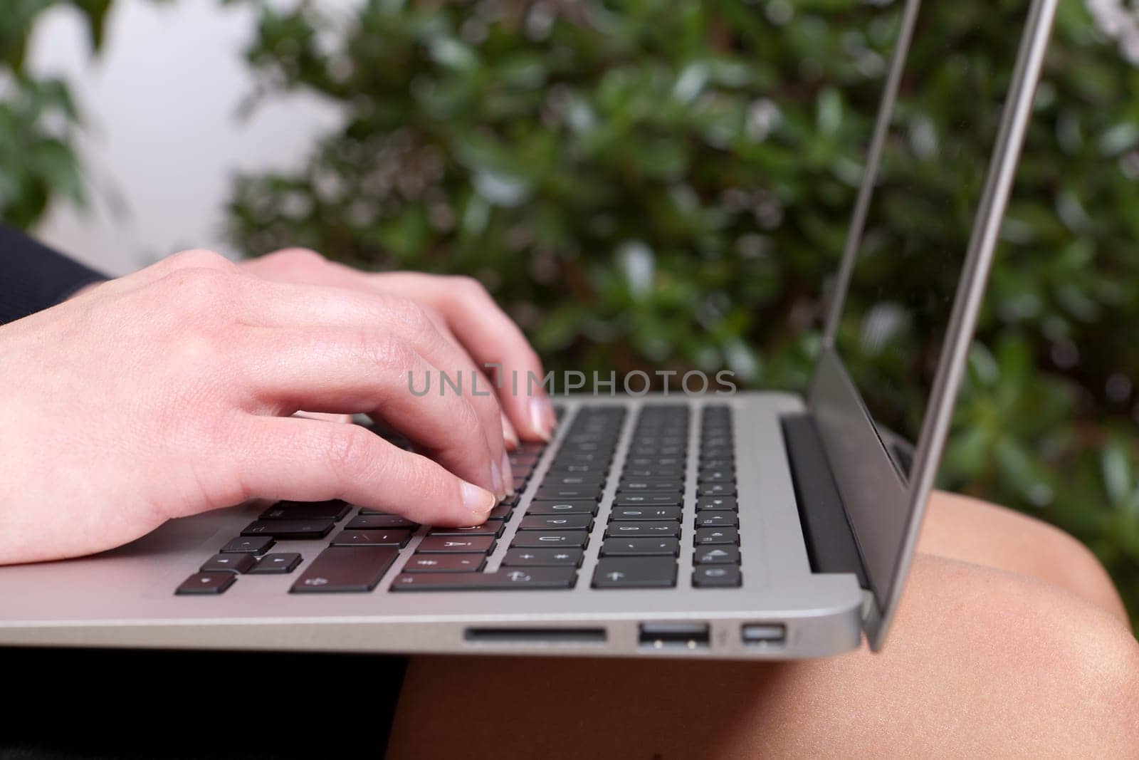 Young businesswoman with a notebook on her knees working on