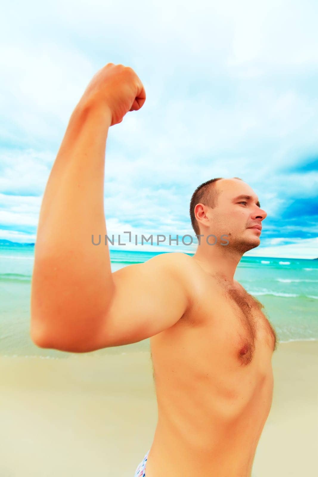 Funny man is showing muscular. Wide-angle lense photo