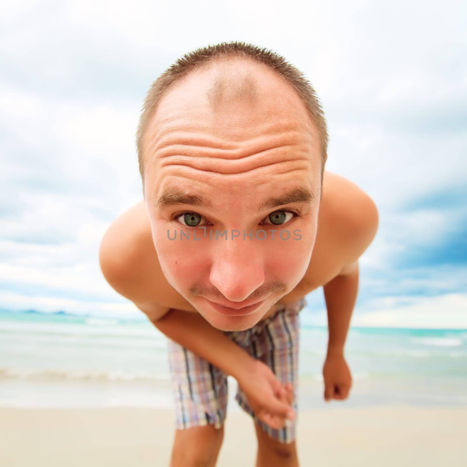 Funny man is looking from the beach