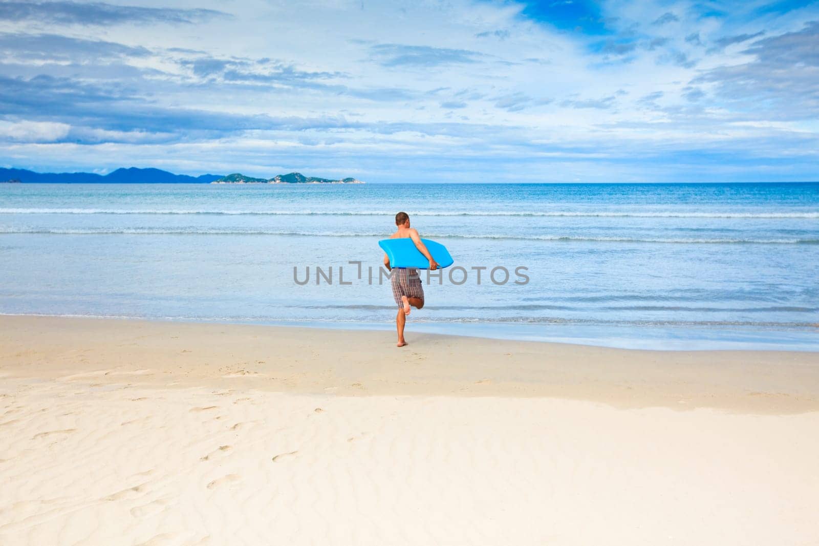 Man with body board on the tropical beach