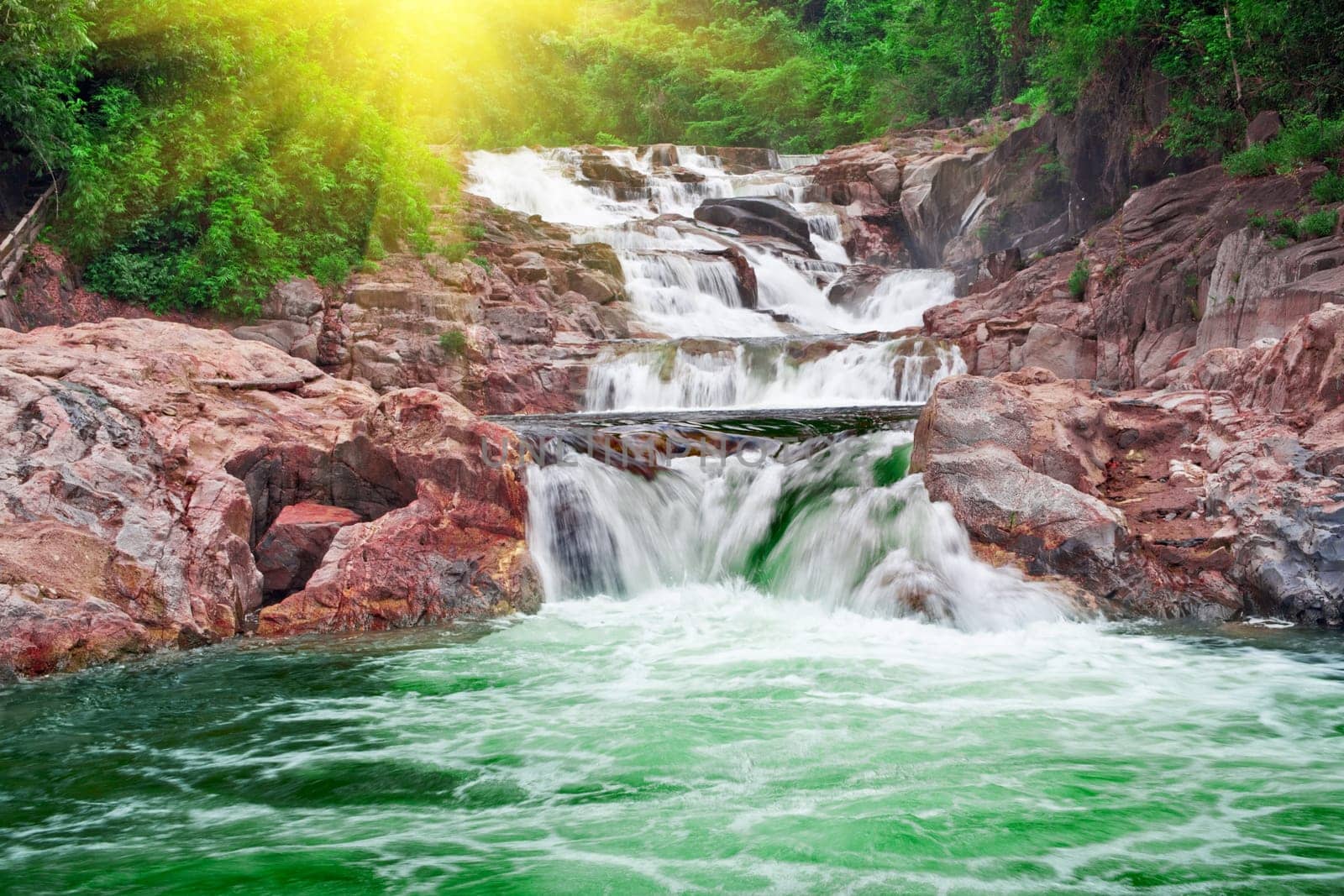 Waterfall in tropical forest at sunny day