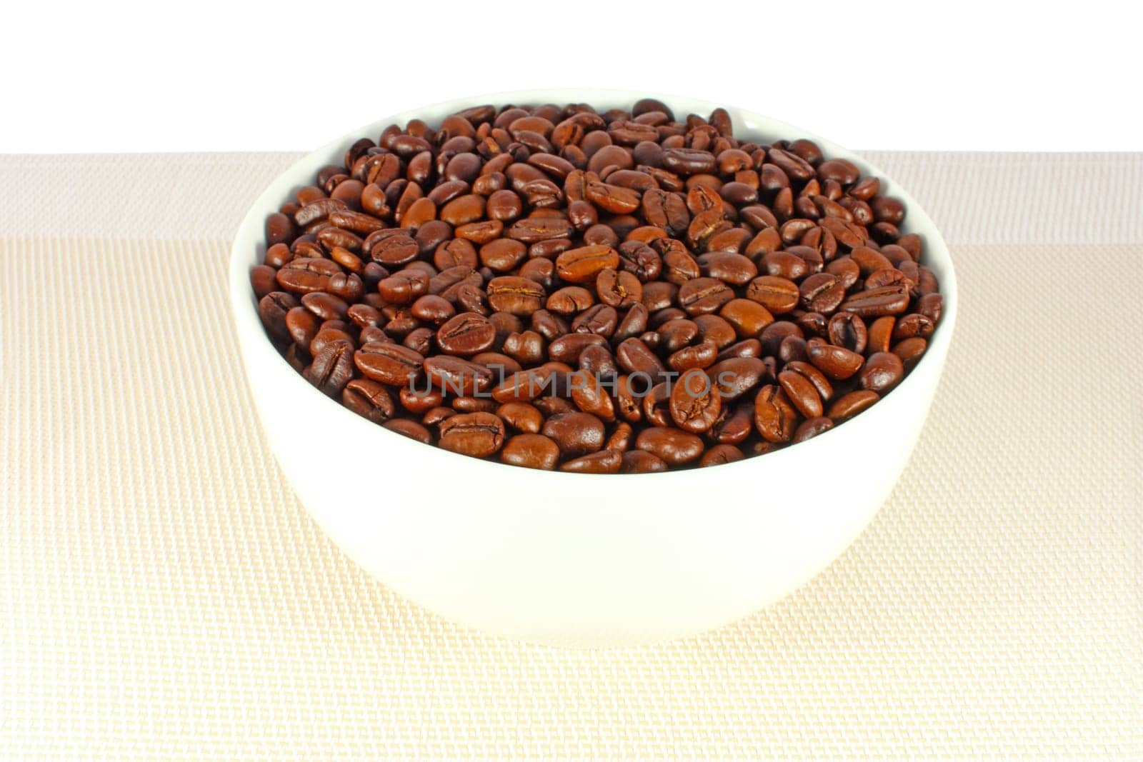 Roasted coffee beans in a white bowl