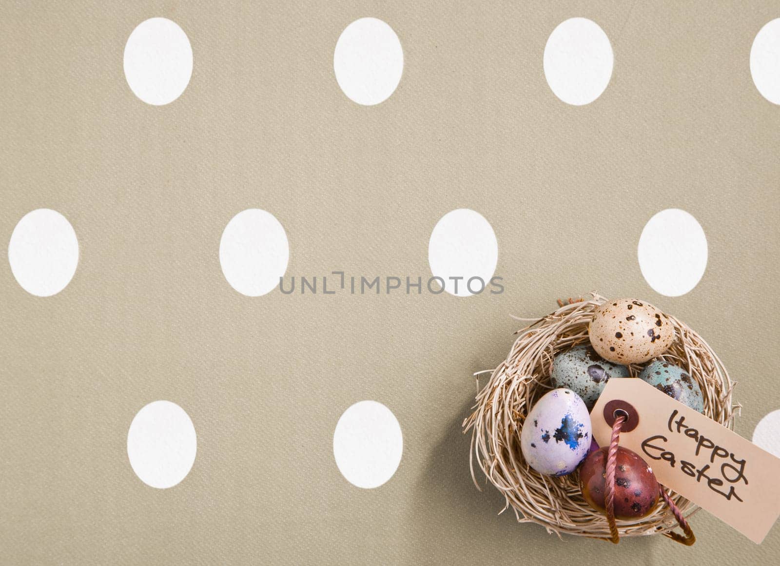 Small nest containing colored eggs over a Easter concept background