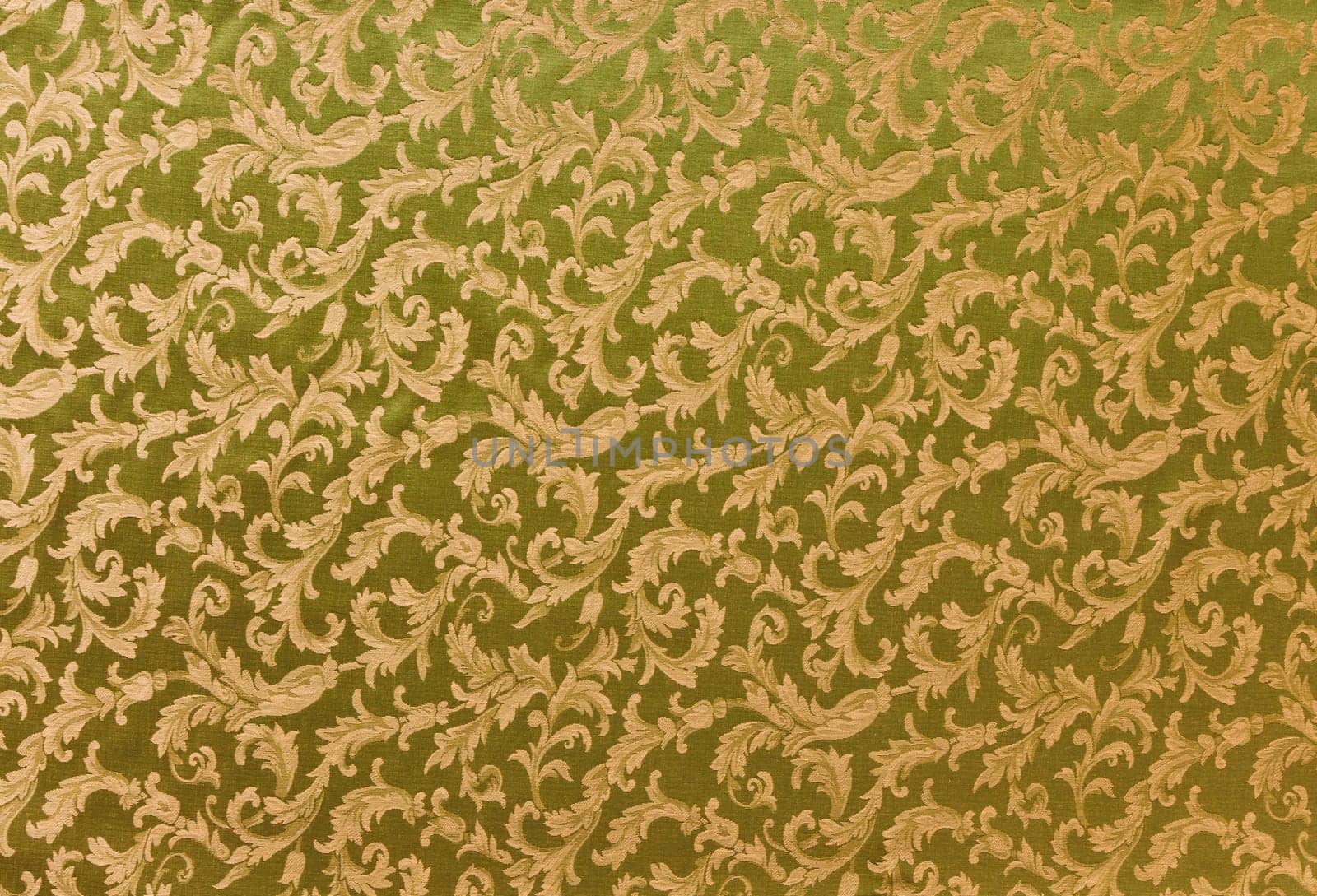 Abstract background of a heavy golden brocade fabric with interwoven repeat design.