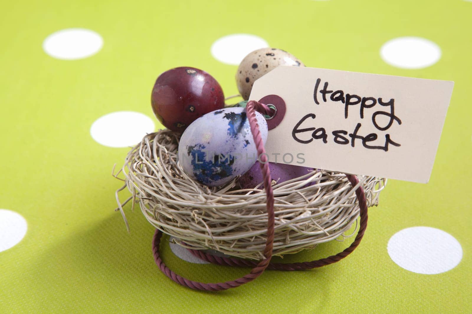 Colored eggs in a small nest with a Happy Easter tag