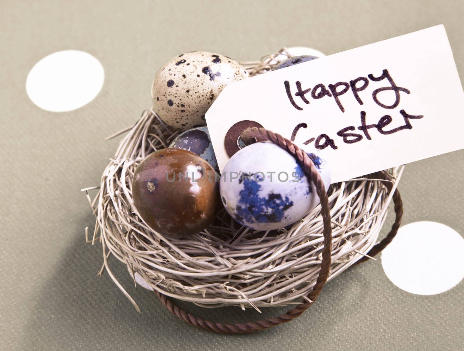 Colored eggs in a small nest with a Happy Easter tag