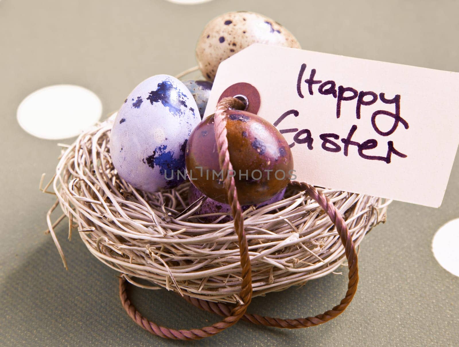 Colored eggs in a small nest with a Happy Easter tag